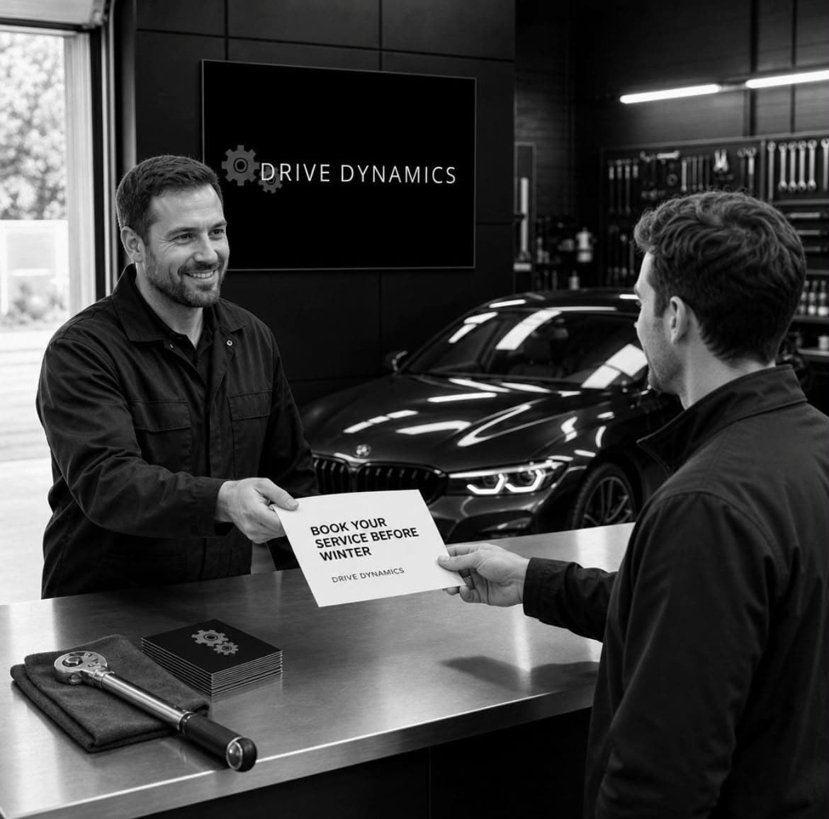 Technician handing paperwork to a customer at the counter