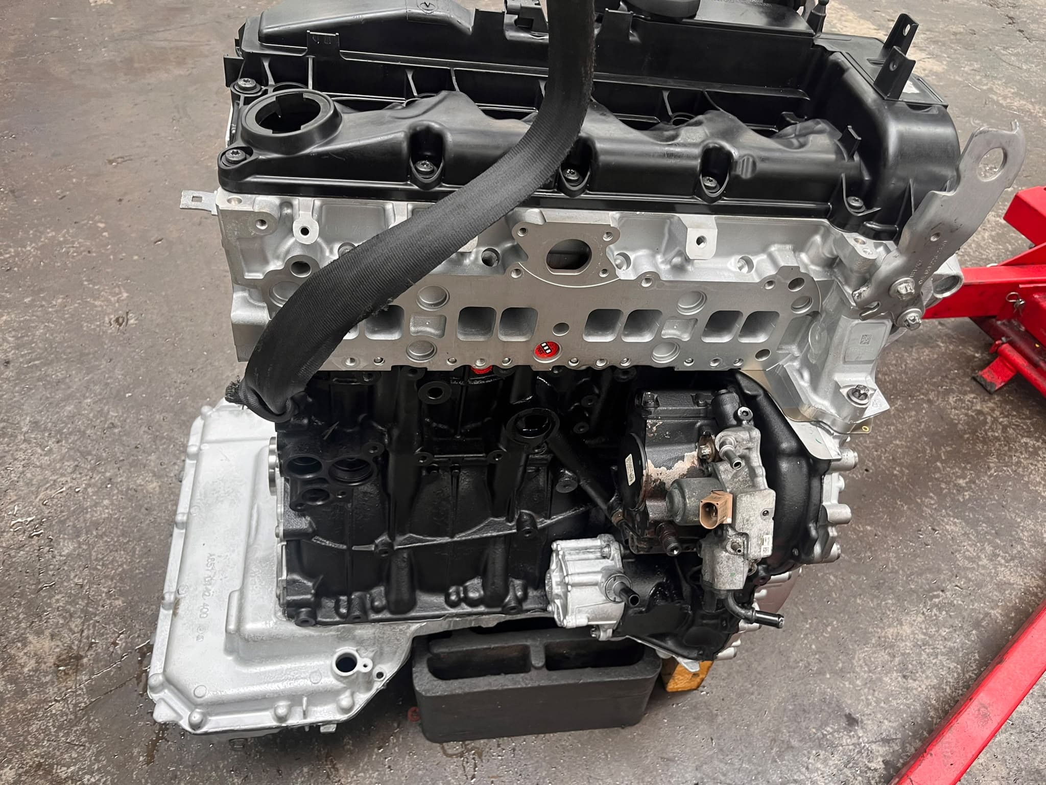 Engine block on the workshop floor during a rebuild